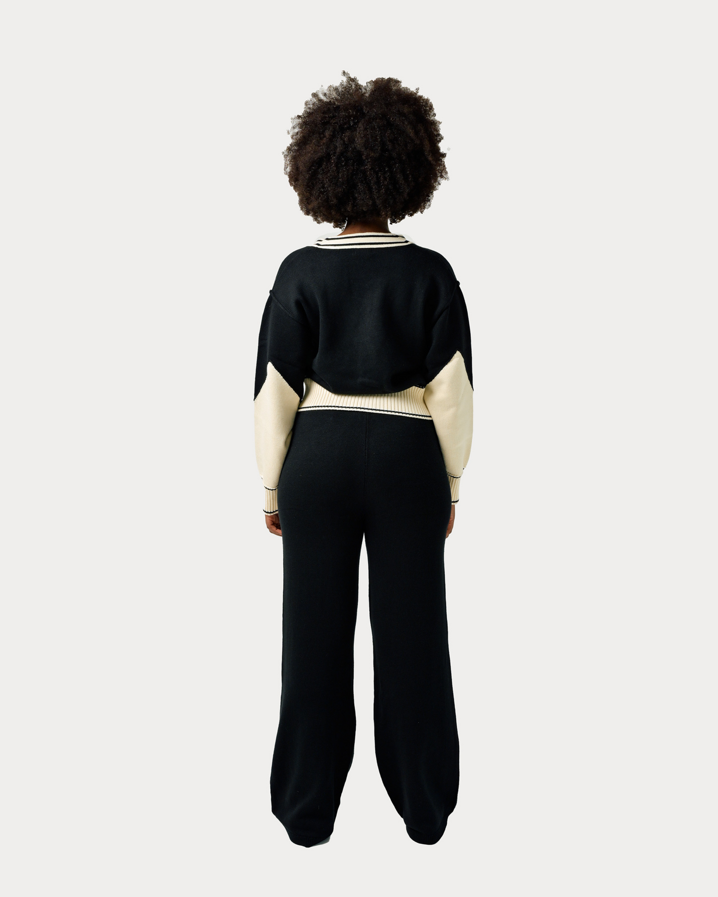 Model is wearing size M in Byrd Knit Classic Pants in black and cream colorway.