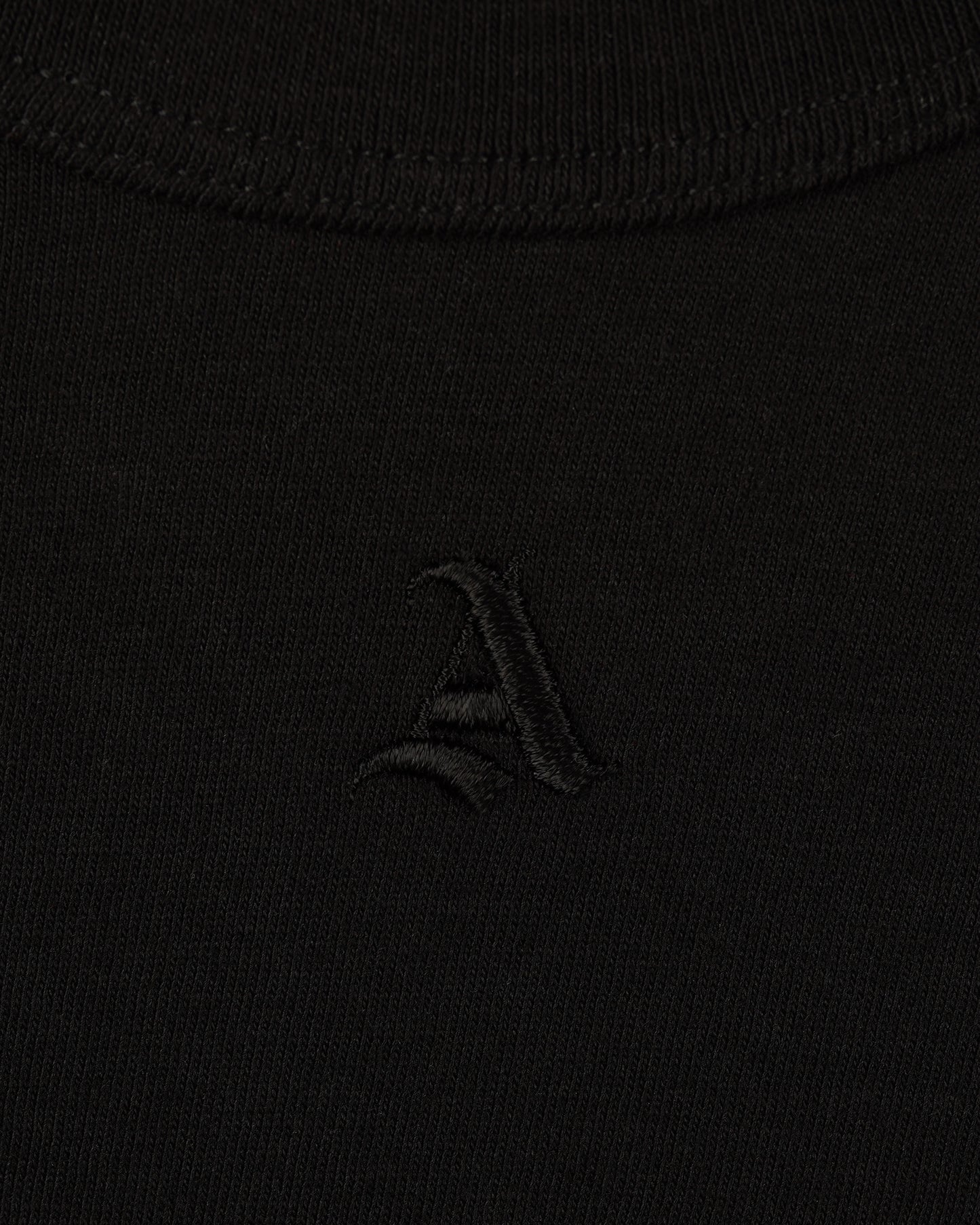 Detail View of Tonal Signature 'A' Logomark on Baby Tee in Black by Aseye Studio