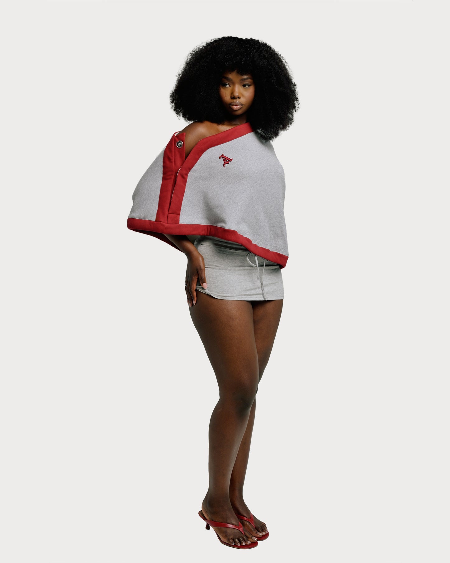 Model is wearing size S/M in our Jolie Varsity Draped Sweatshirt Top in Heather Gray with Deep Red Trim