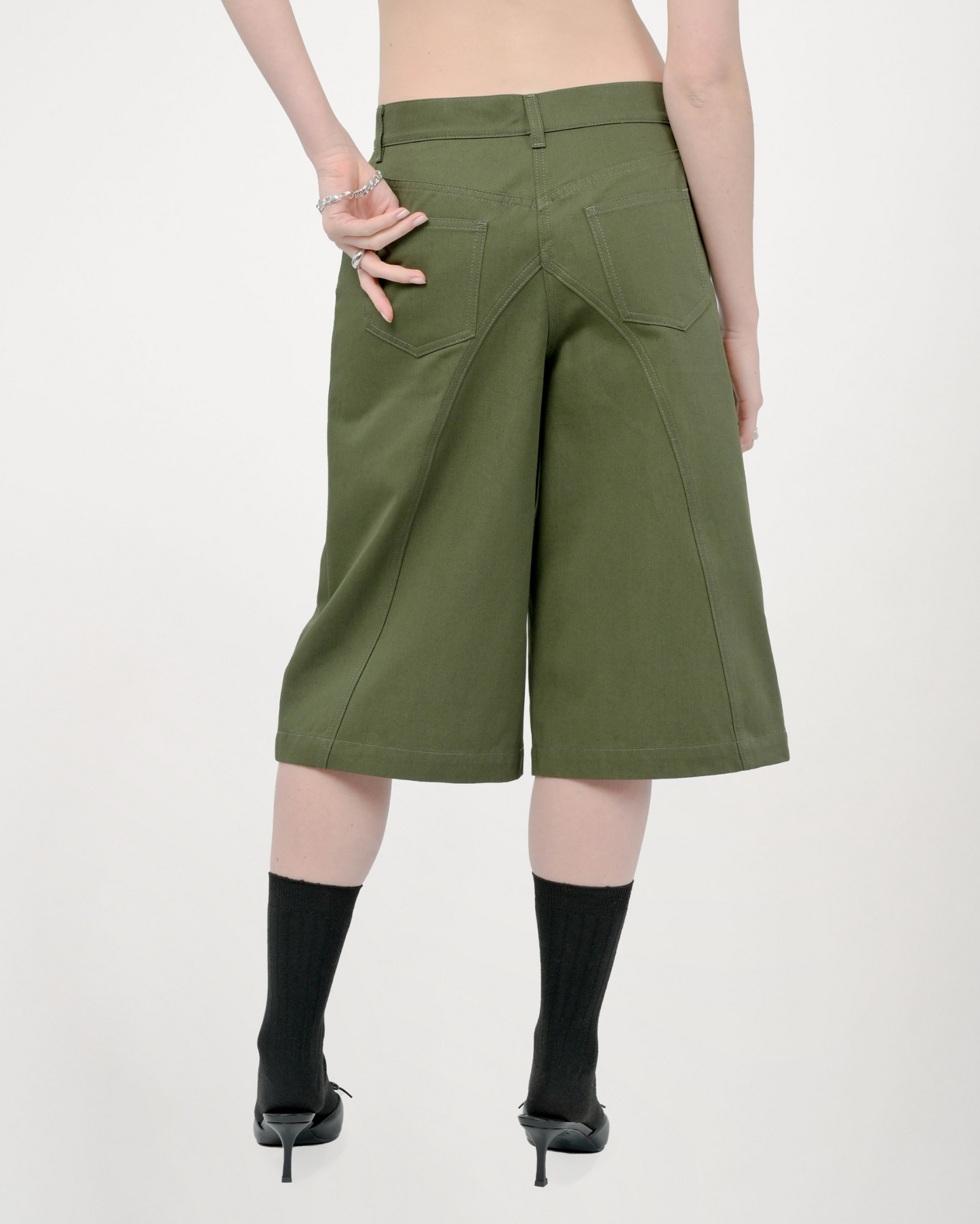 Model is wearing size Small in Tommi Shorts in Olive Green by Aseye Studio