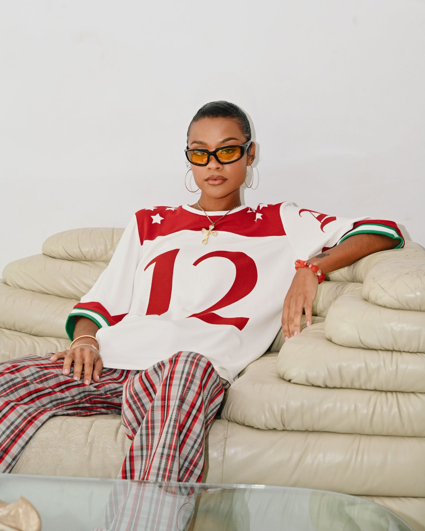 Model is wearing a Size small in the Taylor Football T-shirt by Aseye Studio