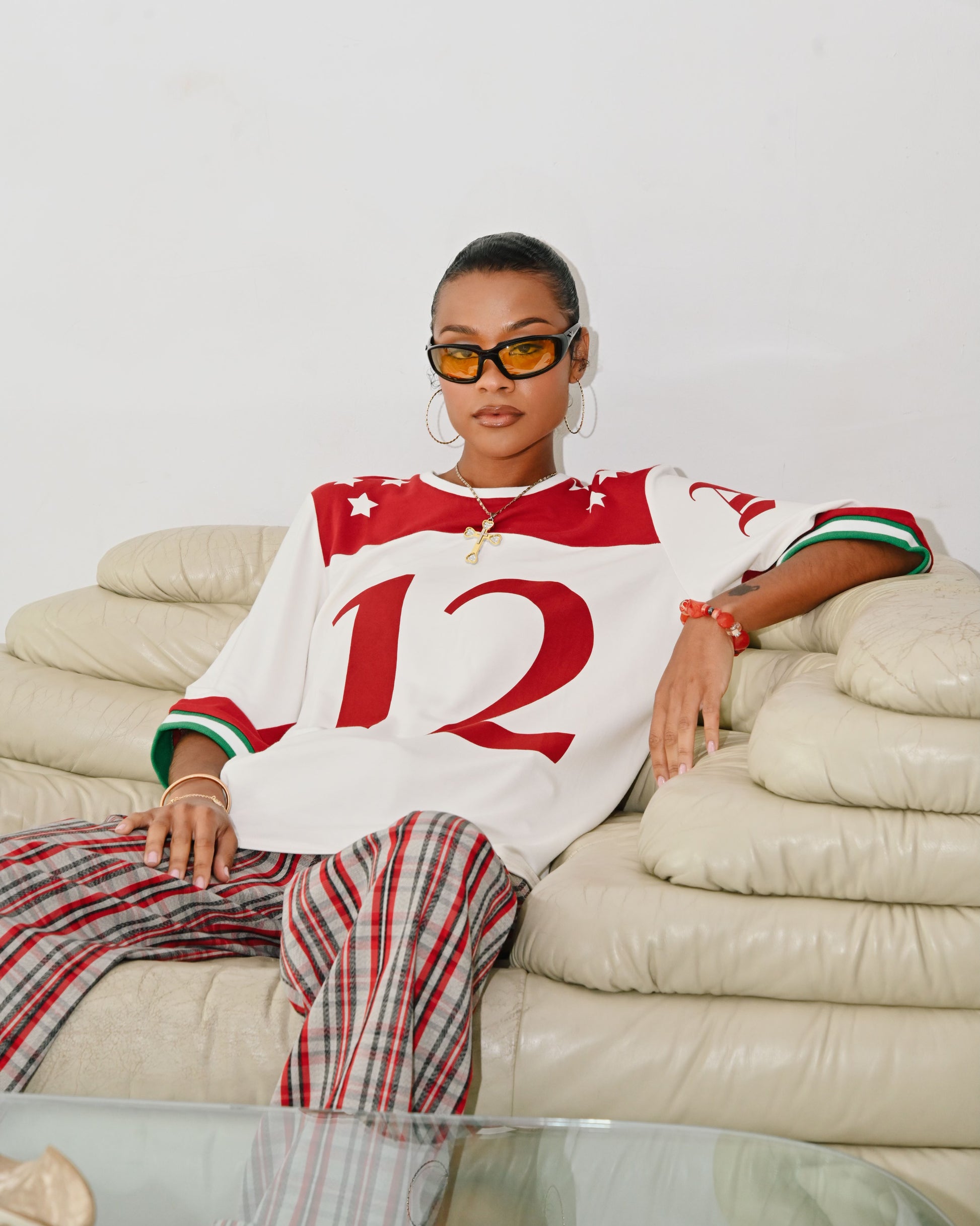 Model is wearing a Size small in the Taylor Football T-shirt by Aseye Studio