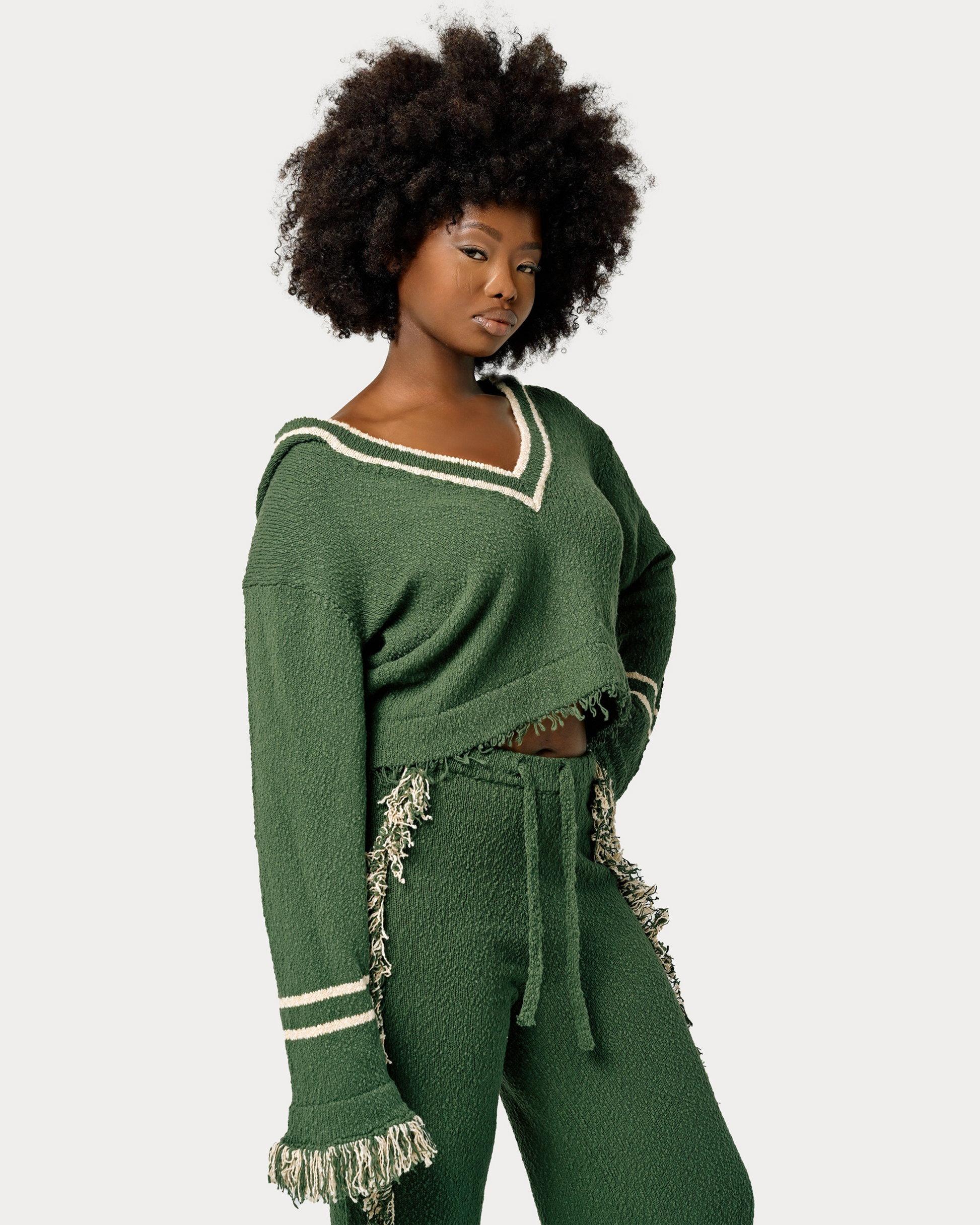 Model is wearing size M in Andy Knit Fringe Top in Green colorway. 