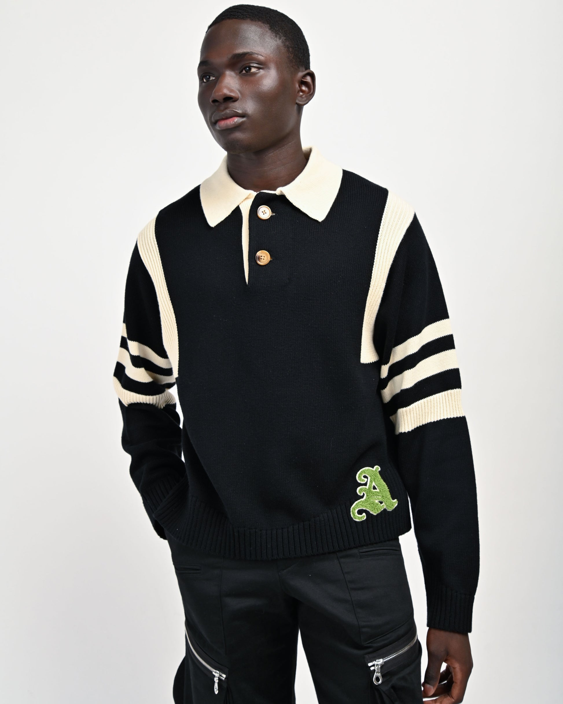 Model is wearing size Medium in the Kai Rugby Knit Sweater in Black by Aseye Studio. 