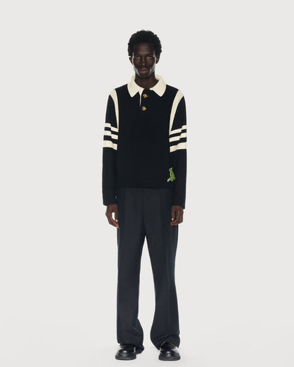 Man wearing an Aseye Studio black and cream striped sweater with a cream color collar on a white background. Shop