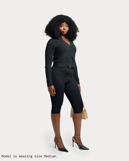 Model is wearing Tynia Zip-Up Knit Track Cardigan in size medium and black colorway. 