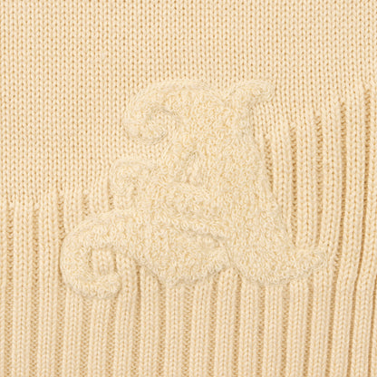 Detail View of Chenille Signature 'A' Logo and Curved Ribbed hem on Kai Rugby Knit Sweater by Aseye Studio
