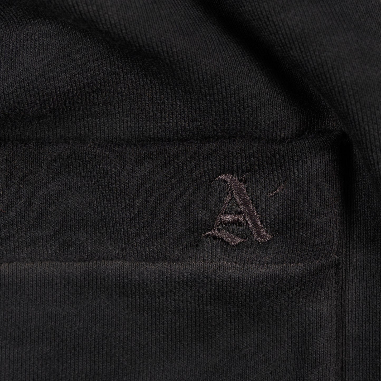 Detail View of Embroidered 'A' on Allora Track Pants by Aseye Studio