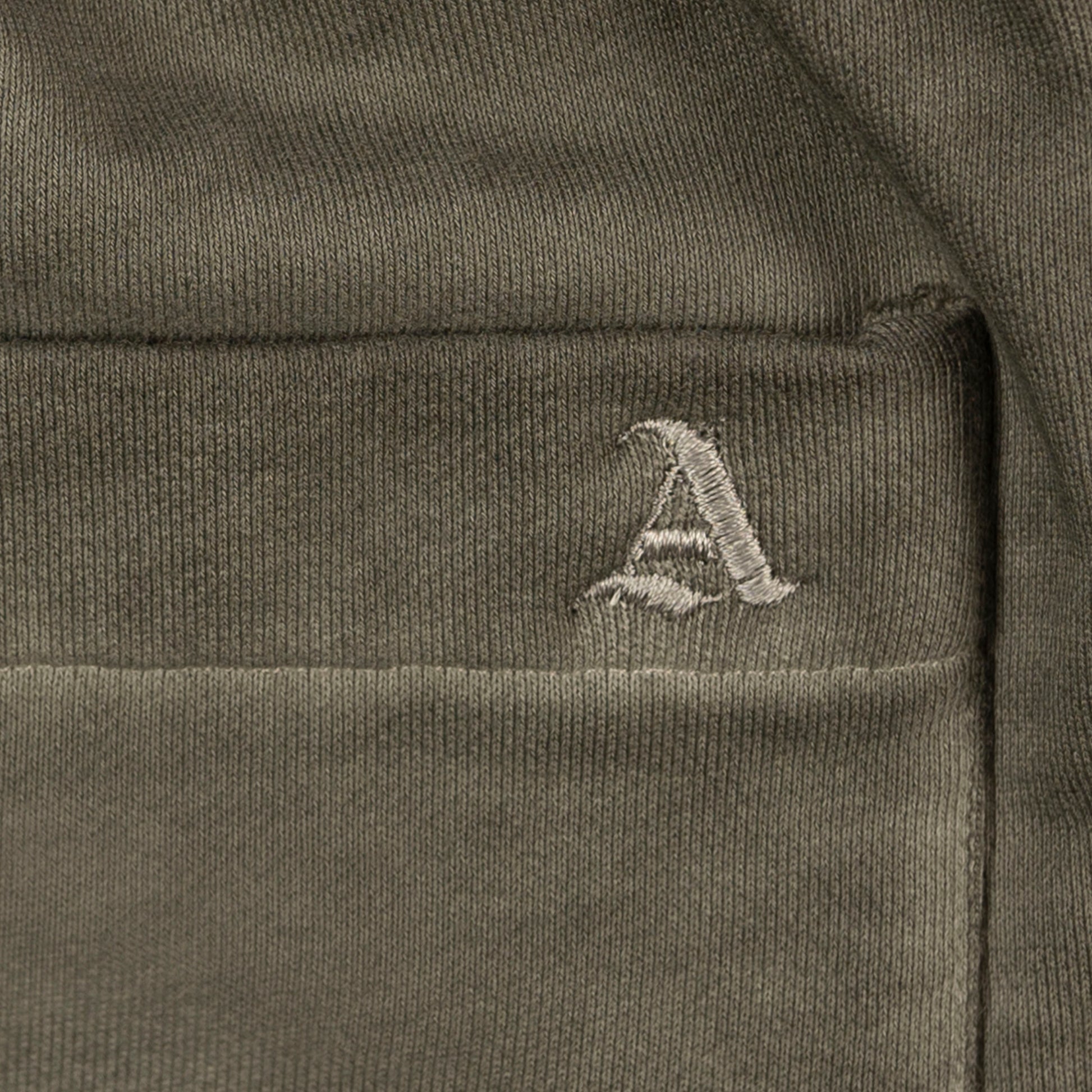 Detail View of Embroidered Signature 'A' Logo on Allora Track Pants by Aseye Studio