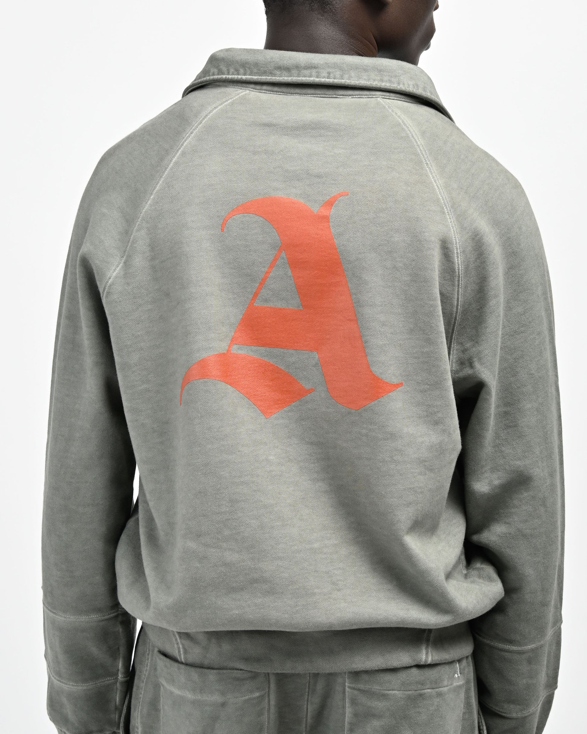 Back View of model in August Pullover Sweatshirt and Printed signature 'A' logo by Aseye Studio