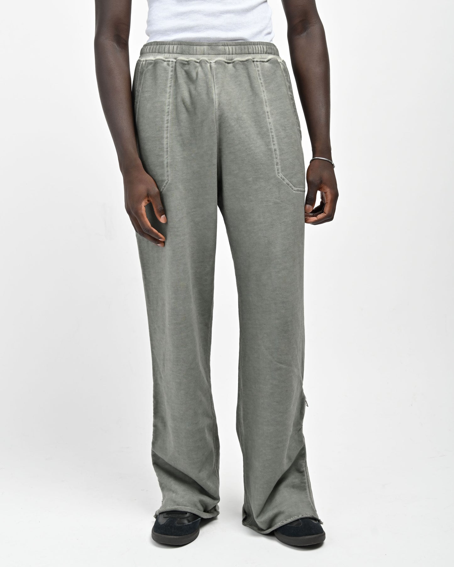 Front View of Model in Allora Track Pants in Muted Green by Aseye Studio