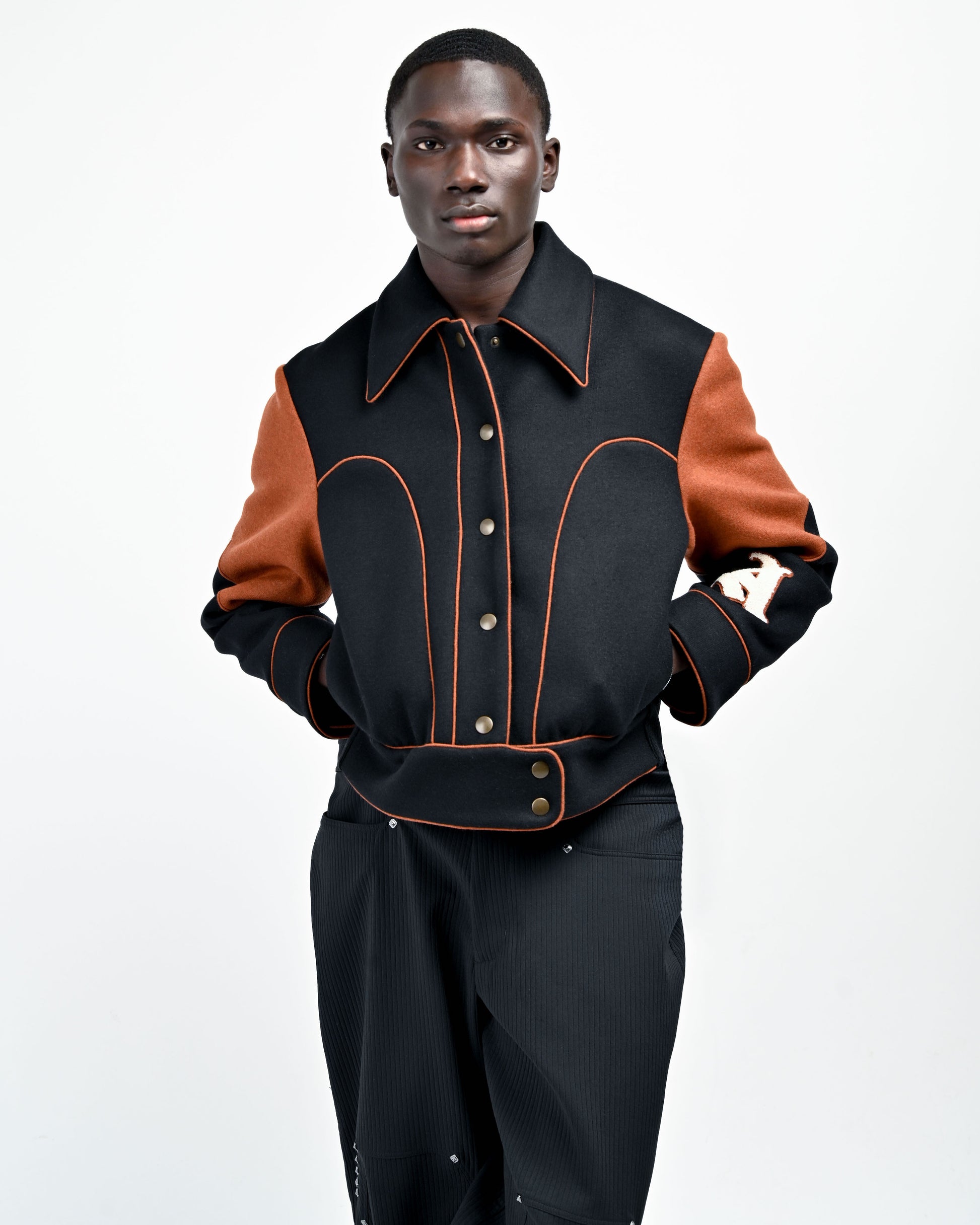 Model is wearing Rue Varsity Jacket by Aseye Studio