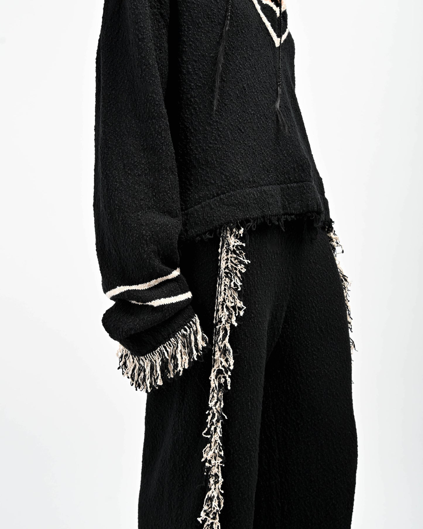 Detail view of Stripe accents and Fringe Detail on Andy Fringe Knit Set in Black and Oatmeal by Aseye Studio