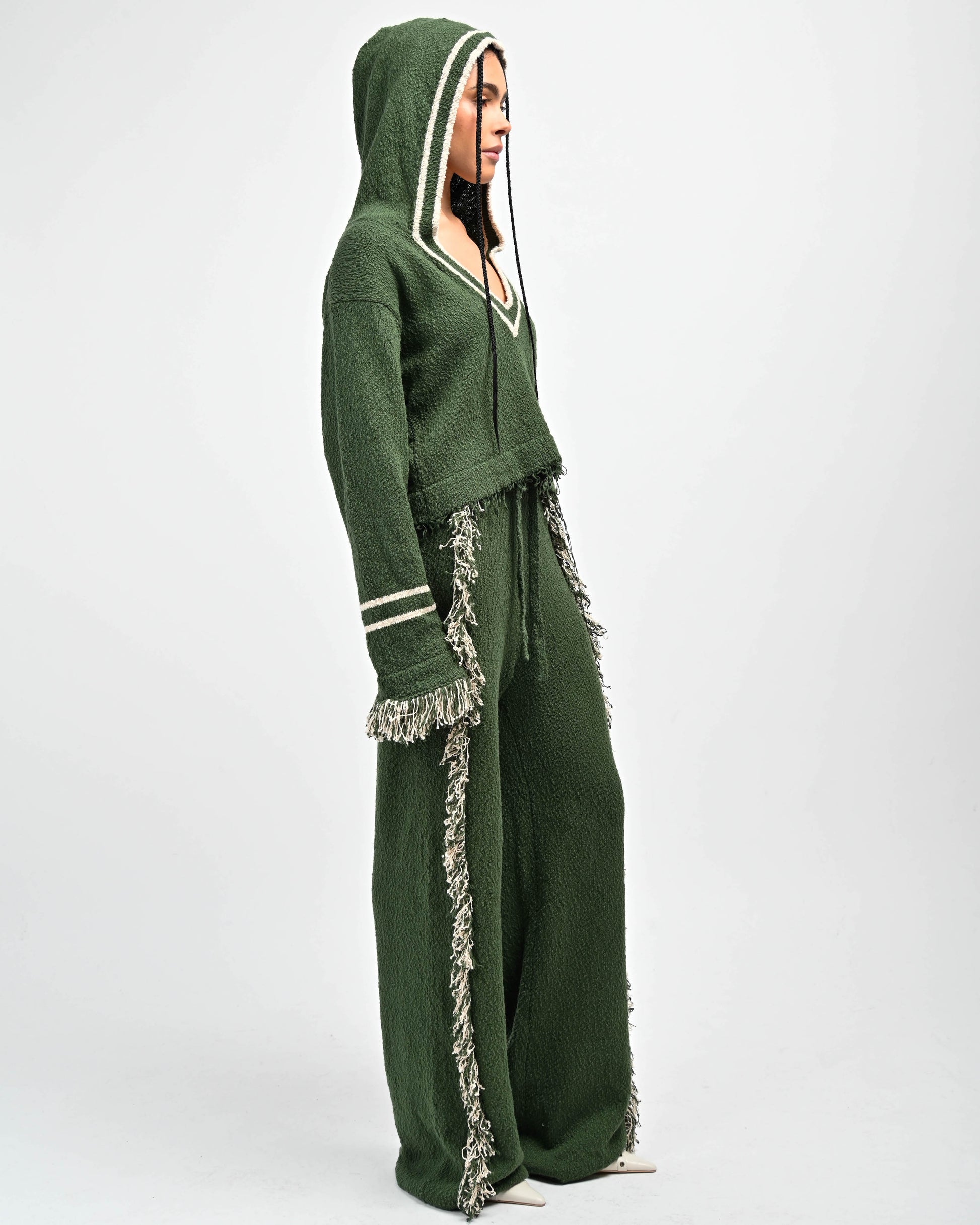 Side View of Model in Andry Fringe Knit Hoodie and Andy Fringe Knit Pants in color green by Aseye Studio