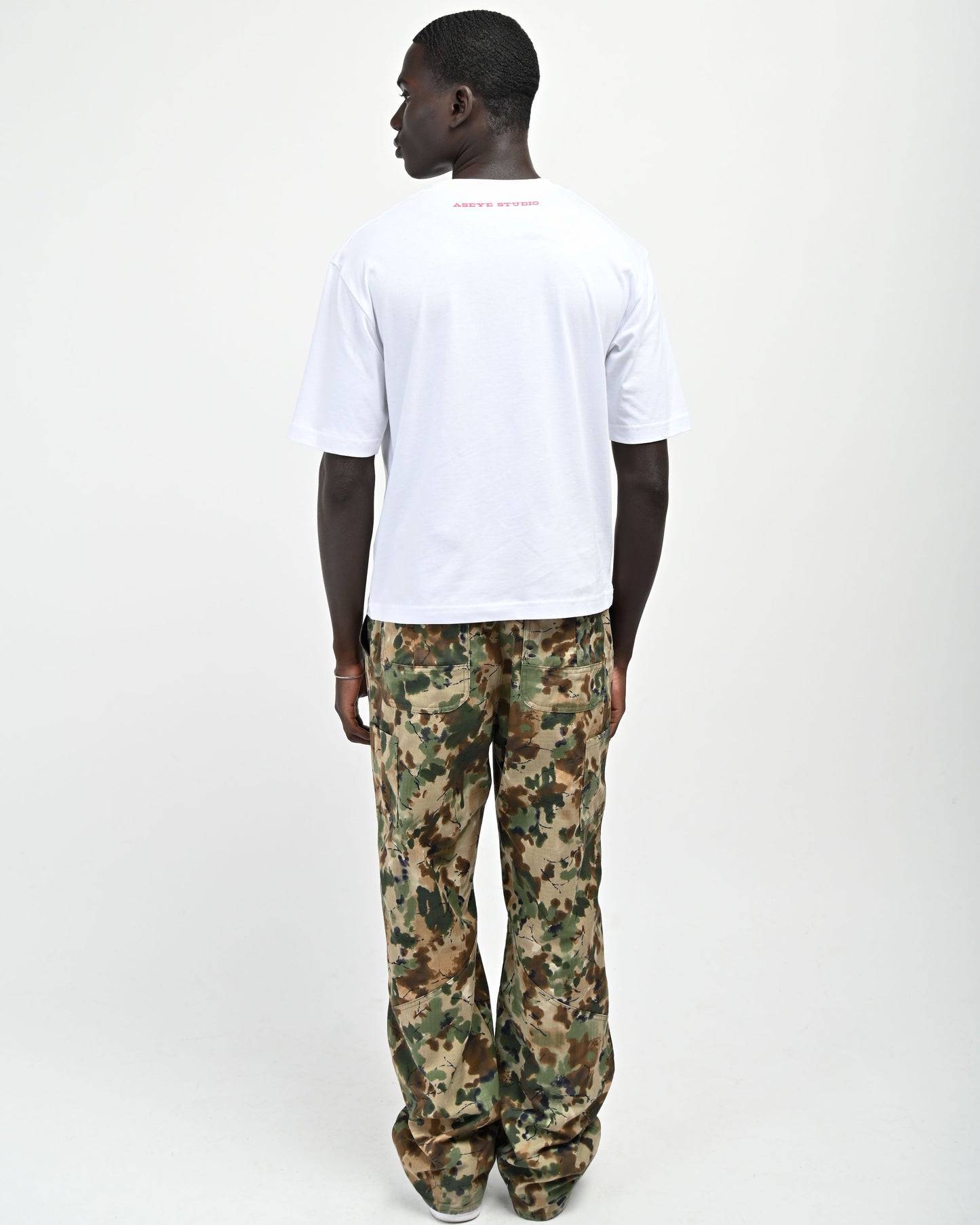 Back View of model wearing Plaid 'A' T-shirt by Aseye Studio 