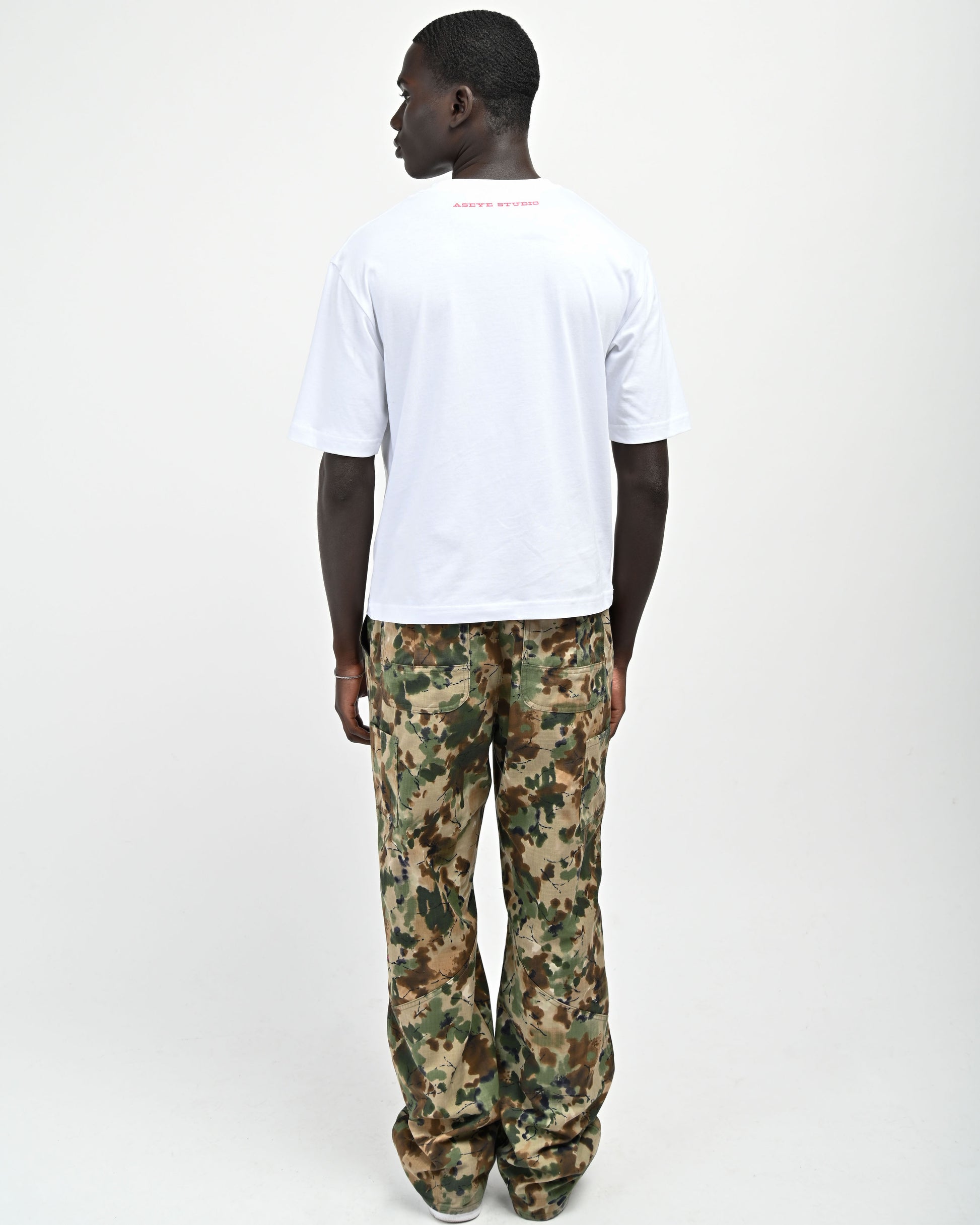 Back View of model wearing Plaid 'A' T-shirt by Aseye Studio 