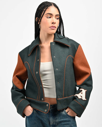 Model is wearing a size Small in Rue Varsity Jacket by Aseye Studio
