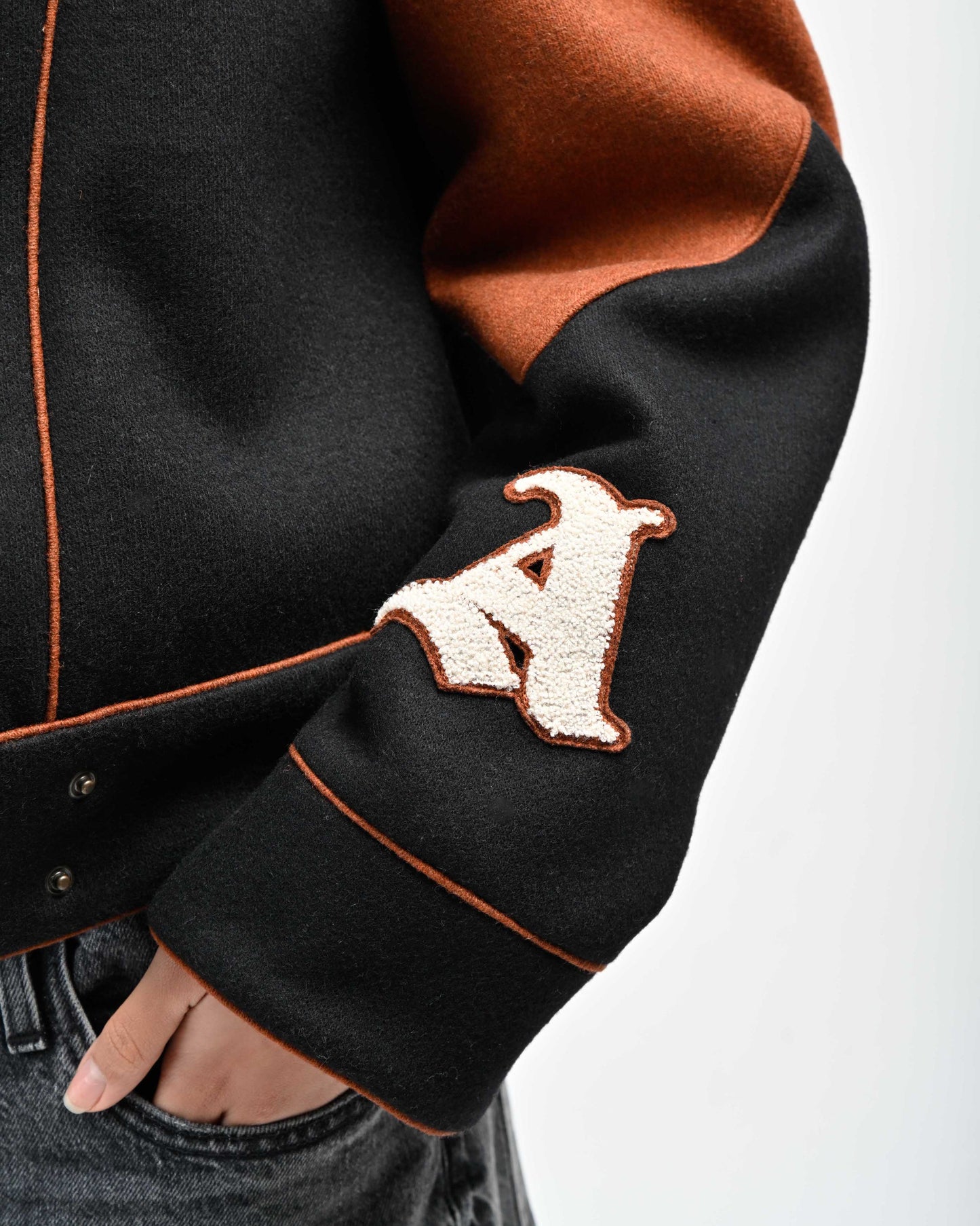 Detail View of Chenille Signature 'A' Letter and Piping on Rue Varsity Jacket by Aseye Studio
