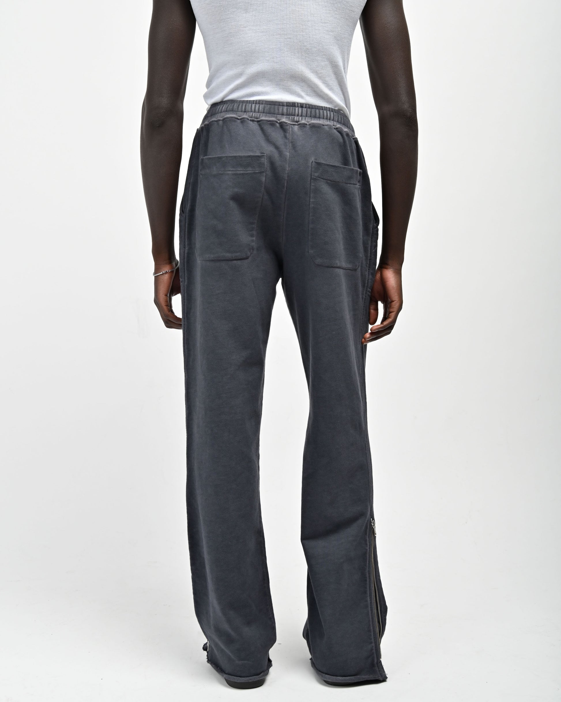Back View of Man in Allora Track Pants in color Indigo Blue