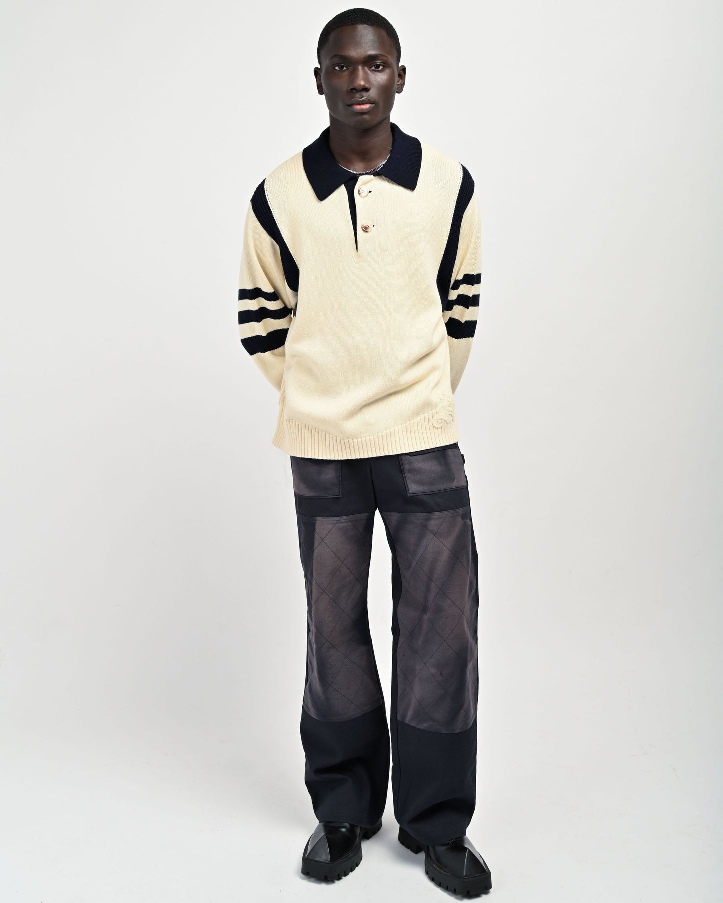 Model is wearing Kai Rugby Sweater in Cream and Black by Aseye Studio