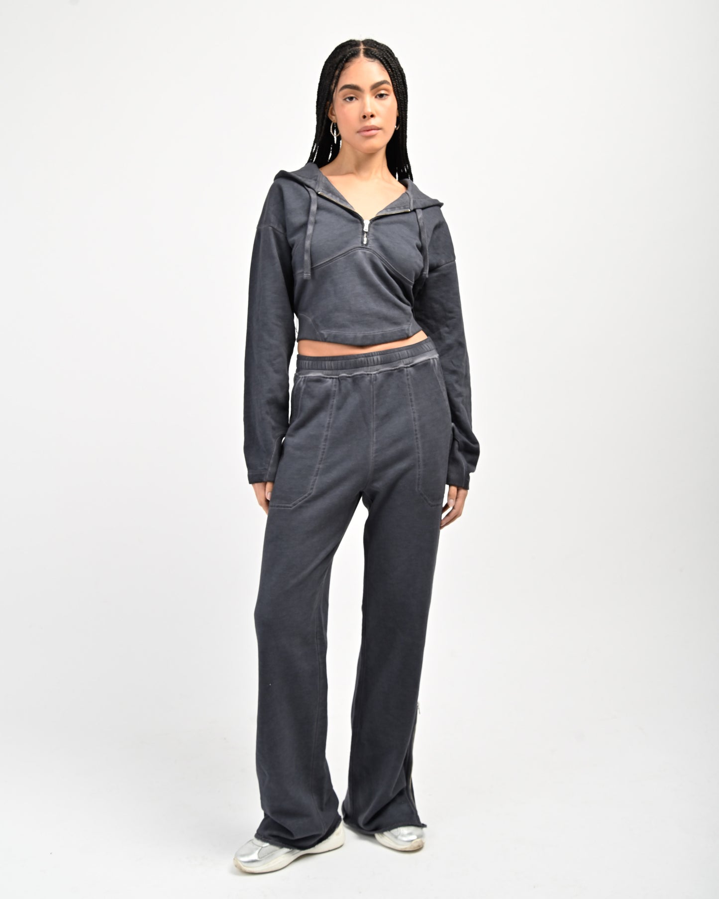 Model is wearing Allora Half-Zip Hooded Sweatshirt and Allora Track Sweatpants by Aseye Studio.