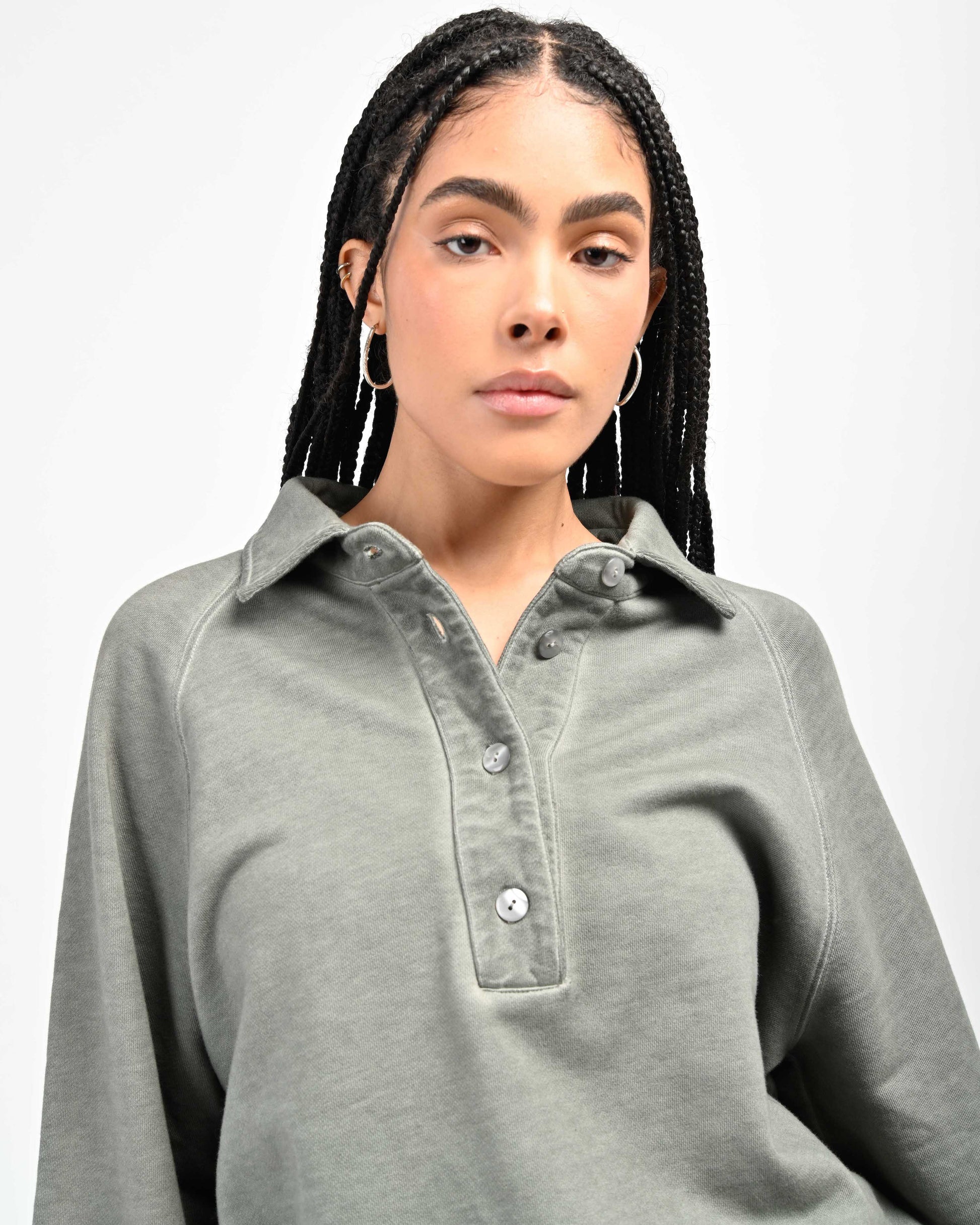 Detail View of Mother-of-pearl buttons on August Pullover Sweatshirt by Aseye Studio worn by model