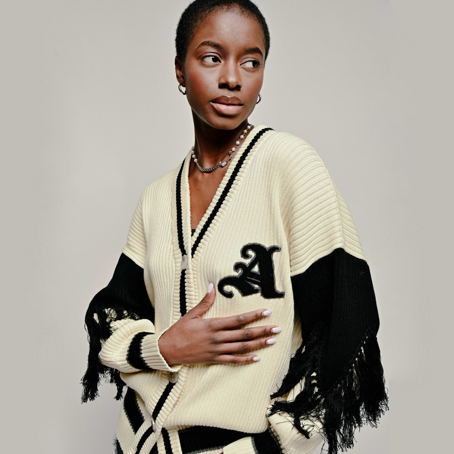 Model in Aseye Studio Varsity Cardigan in Size Small/Medium