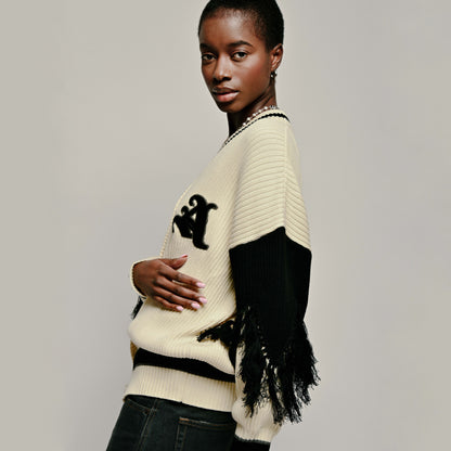 Model wearing Aseye Studio Varsity Cardigan in Cream and Black