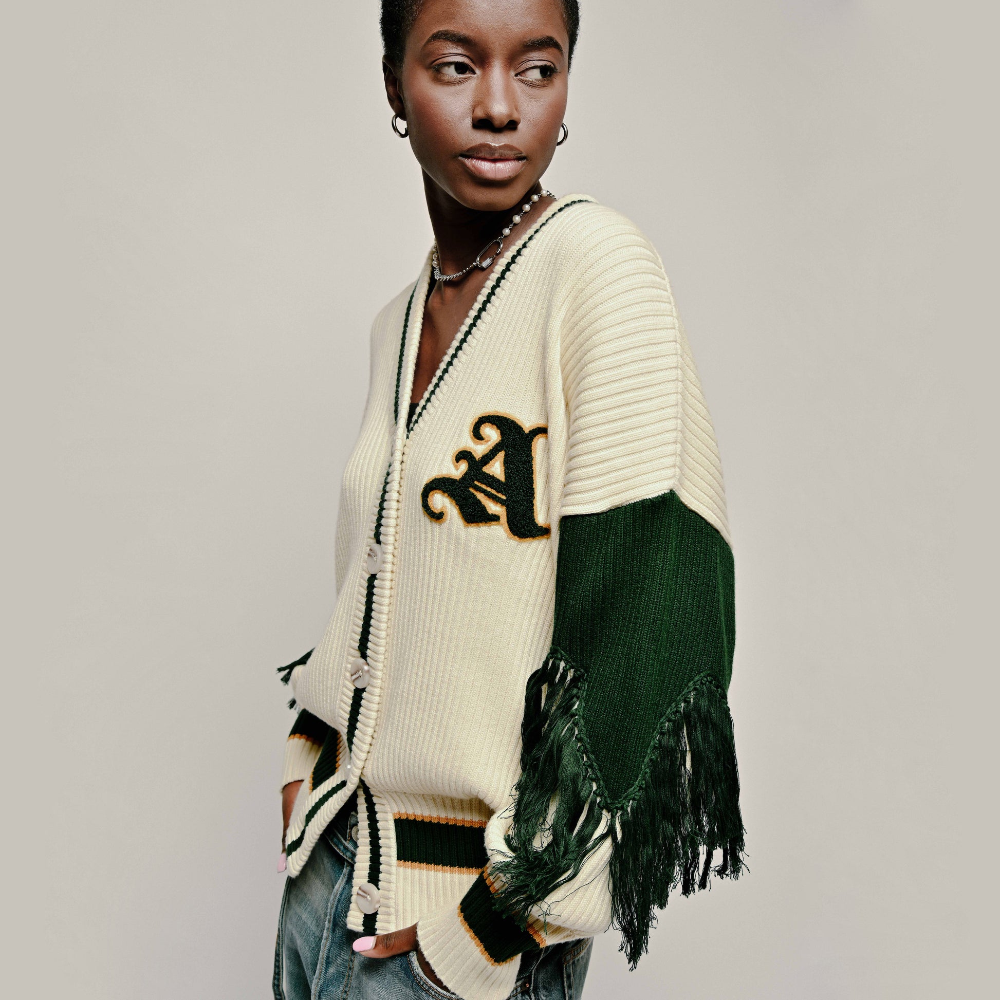Model in Varsity Cardigan in Cream and Emerald Green