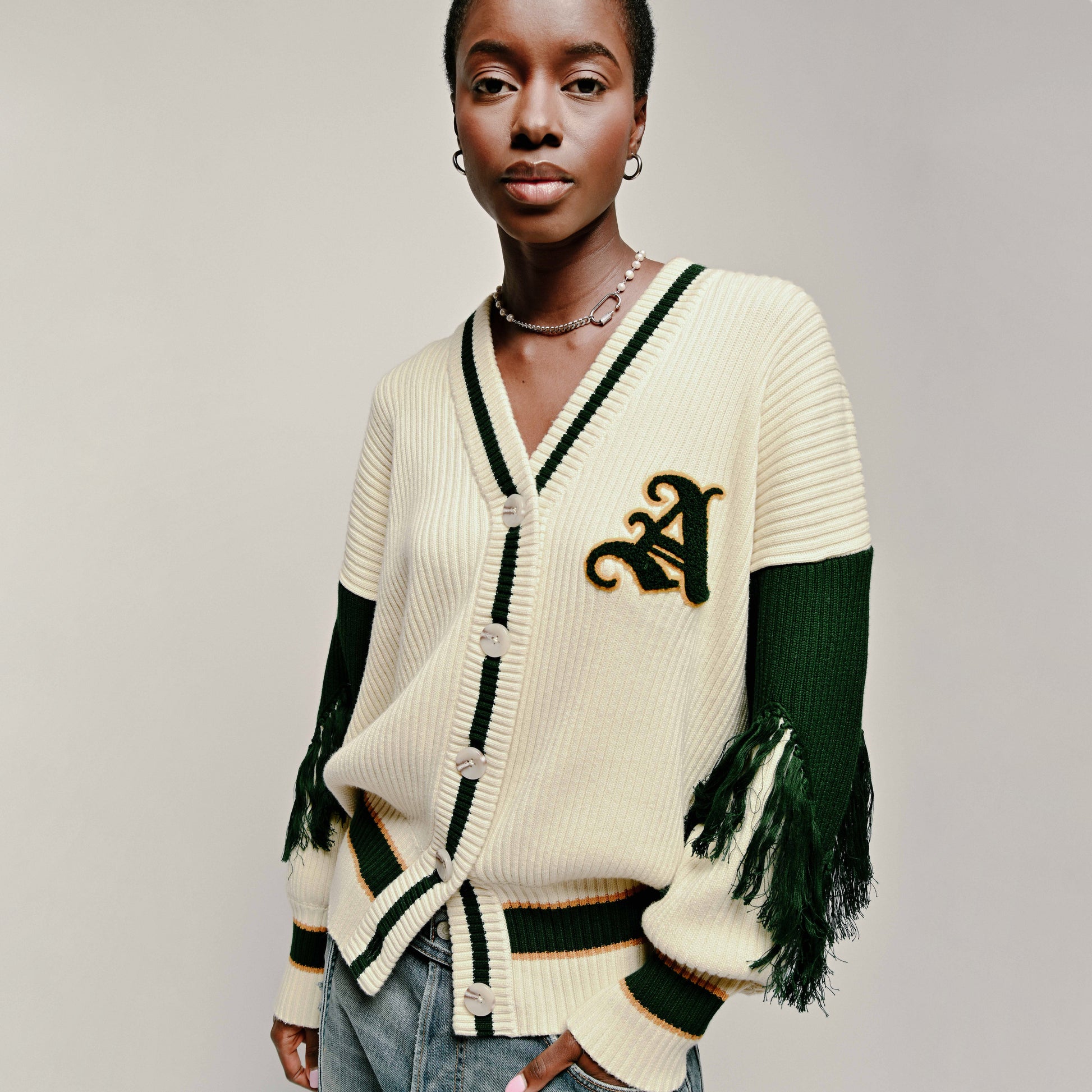 Model in Varsity Cardigan in Cream and Emerald Green