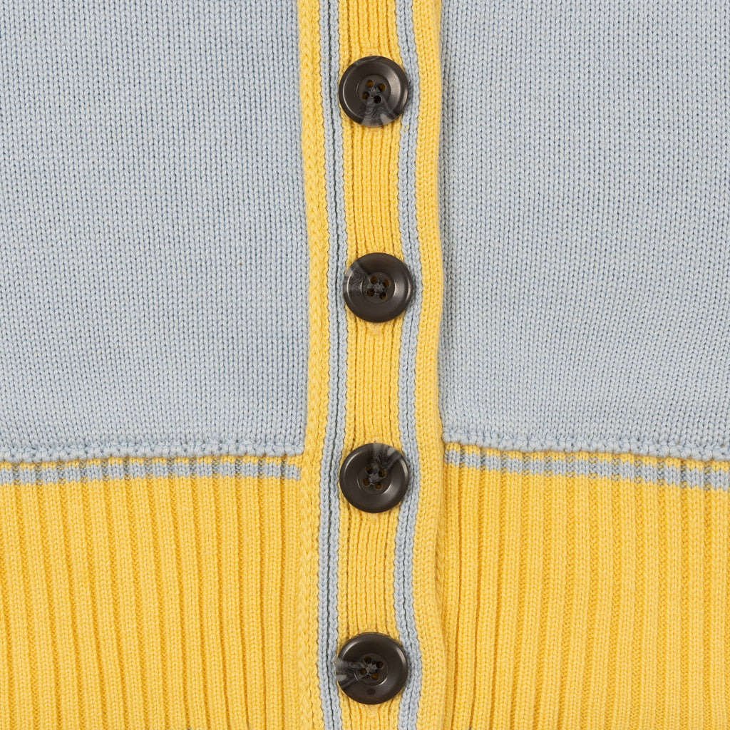 Detail Shot of Dark Grey Buttons and ribbed hem on the Byrd Classic Knit Cardigan in Icy Blue Colorway