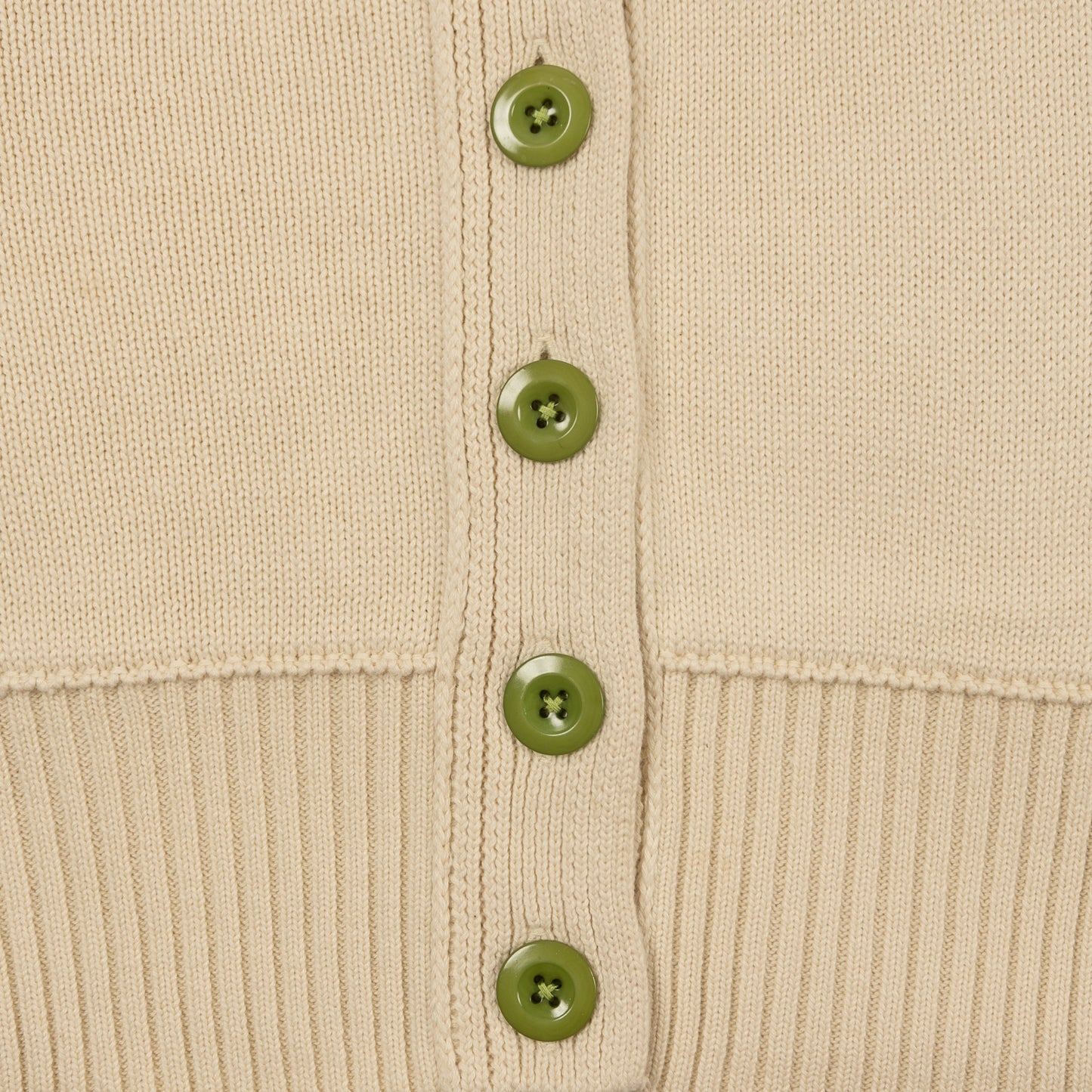 Detail Shot of Jade Green Buttons and Ribbed Hem on the Byrd Classic Cardigan in Cream