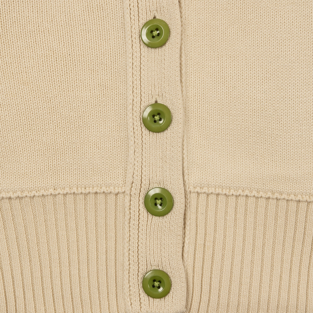 Detail Shot of Jade Green Buttons and Ribbed Hem on the Byrd Classic Cardigan in Cream