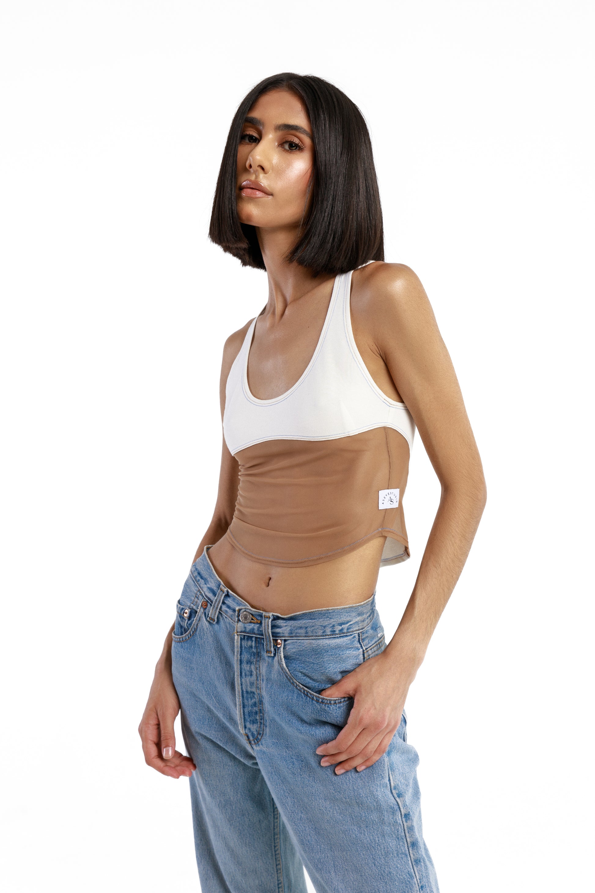 Model is wearing a size X-Small in Kaya Mesh Tank in white