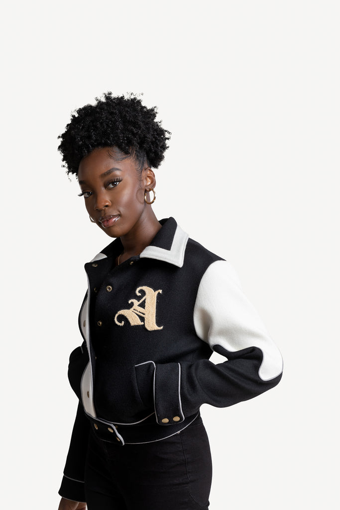 Model is wearing Liz Varsity Jacket in black and size Small.